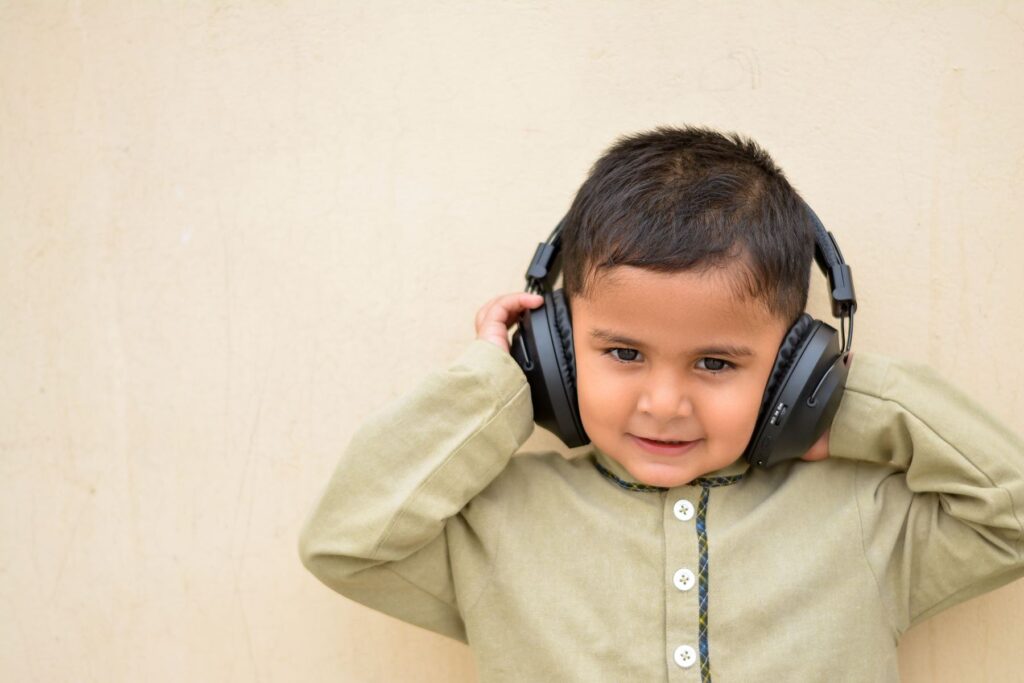 A smiling boy wearing large headphones