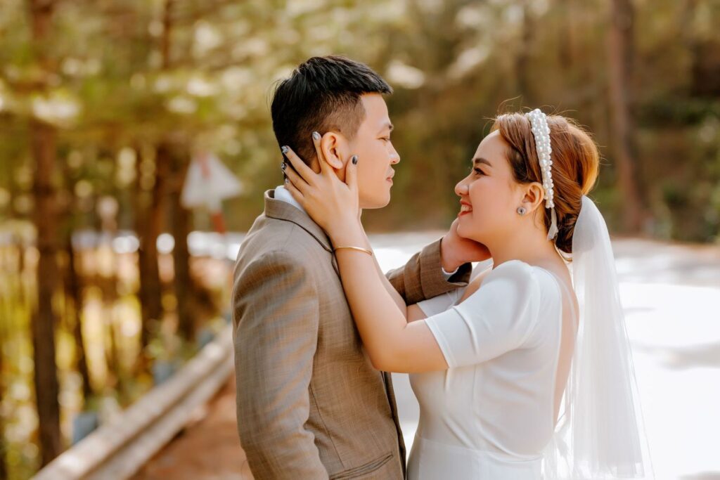 A bride and groom close together outdoors
